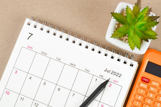 istock July 2022 desk calendar with calculator. 1366976064