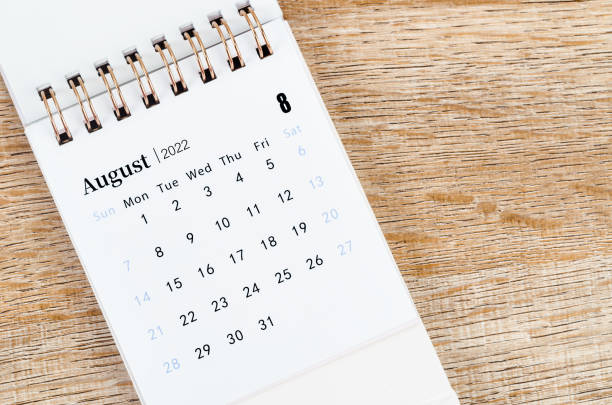 istock August 2022 desk calendar on wooden background. 1366976065