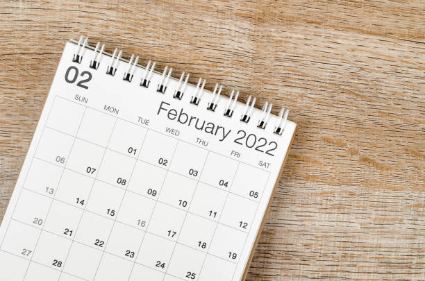 istock February 2022 desk calendar on wooden background. 1366976073