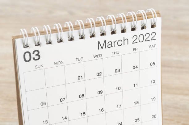 istock March 2022 desk calendar on wooden background. 1366976082