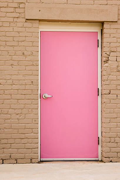 istock Pink Door in Beige Brick Wall, Close Up 136697804