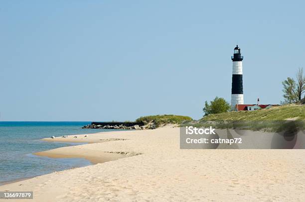 Lighthouse And Beach Sand Along Shoreline Michigan Great Lakes Scenery Stock Photo - Download Image Now