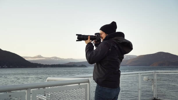 istock Man taking photos of the coastal scenery 1366979667