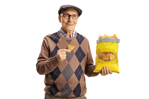 istock Elderly man holding a pack of tortilla chips 1366981648