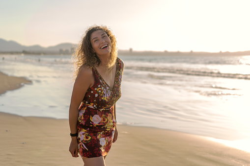 latin young woman happy smiling on the beach, looking at camera, portrait in La Serena