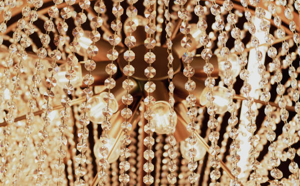 istock Luxury ceiling crystal chandelier in hotel close-up 1366982837