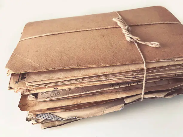 An isolated handmade package  of old letters and documents made of carton and tied with a string