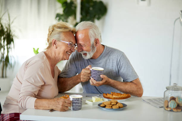 istock Loving senior couple enjoying time together at their dining table 1366985501