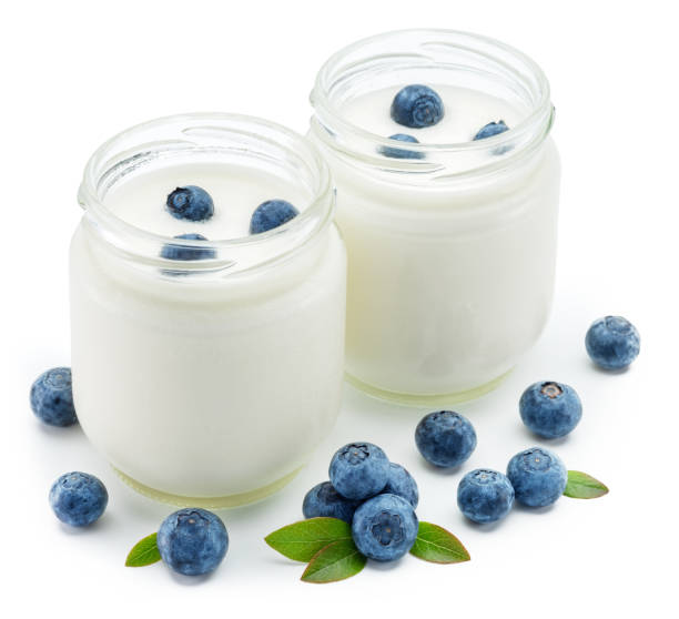 istock Two glass containers with plain yoghurt and berries isolated on white background. 1366988981
