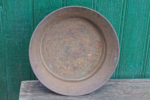 istock one old brown copper basin stands on a gray wooden table 1366989341