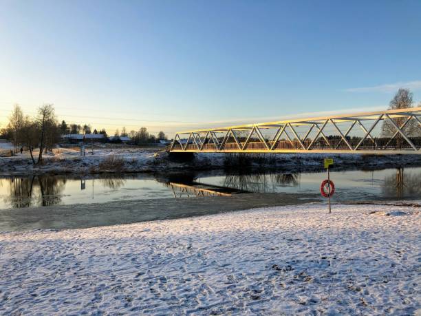 istock Landscape with the bridge over the river on a sunny winter day 1366990037