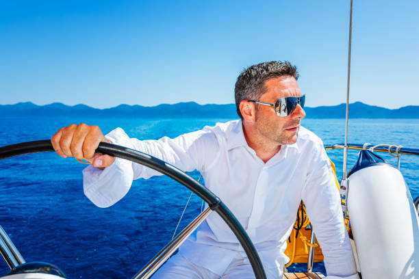 istock Man sailing with sailboat 1366991801