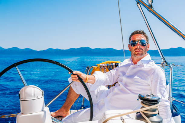 istock Man sailing with sailboat 1366991895