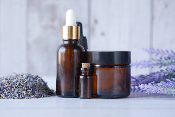 istock Essential lavender oil and flowers on table with copy space 1366992436