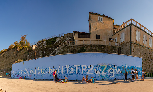 Boqueron, Puerto Rico – March 14, 2020: A beautiful shot of a building wall covered with colorful graffiti against the sea in Boqueron, Puerto Rico