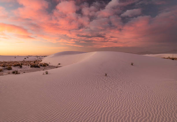 big pink clouds in blue sky sunset over White Sands National Park