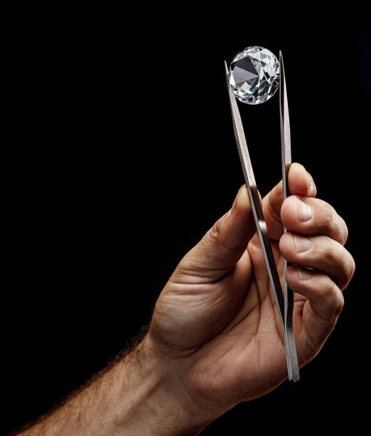 istock Large gemstone in jeweler's hand close up. Gem identifying and evaluating process. 1366993957