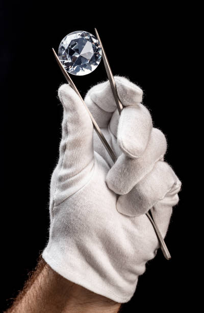 istock Large gemstone in jeweler's hand close up. Gem identifying and evaluating process. 1366994052
