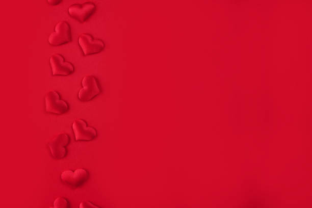 istock Festive St. Valentines background with red hearts on red background with copy space. St.Valentines day background for your project 1366995071