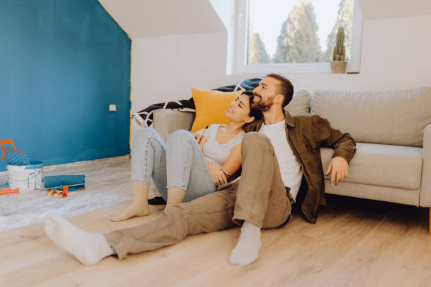 istock Young couple paint together a wall in their apartment 1366996092