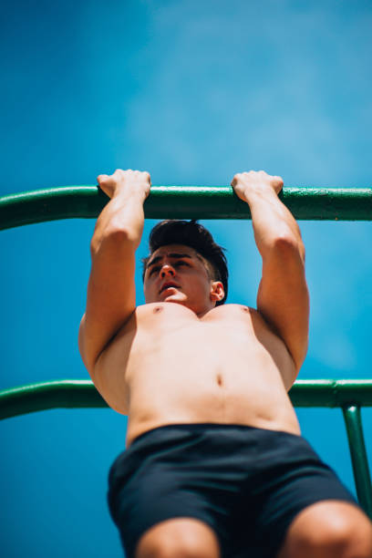istock Sporty shirtless man doing exercises on the horizontal bar 1366996104