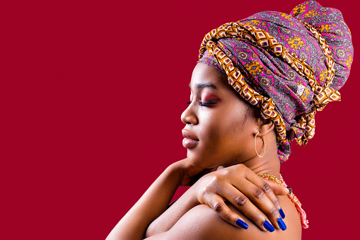 zanzibar african woman in turban and make up with blue nails .