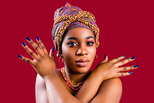 zanzibar african woman in turban and make up with blue nails .