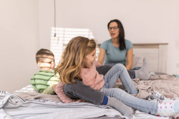 istock Brother and sister having fun on bed 1366996586