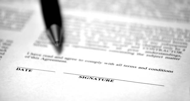 istock Contract on Desk with Black Pen Binding Agreement Legal 1366997567