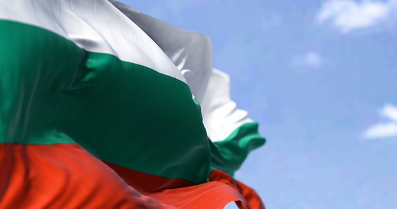 Detail of the national flag of Bulgaria waving in the wind on a clear day. Democracy and politics. Patriotism. Selective focus.