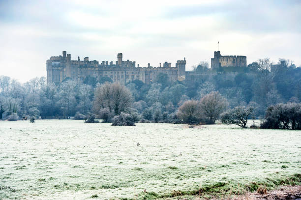 a gothic castle walls towers and battlements. union jack flying on far tower