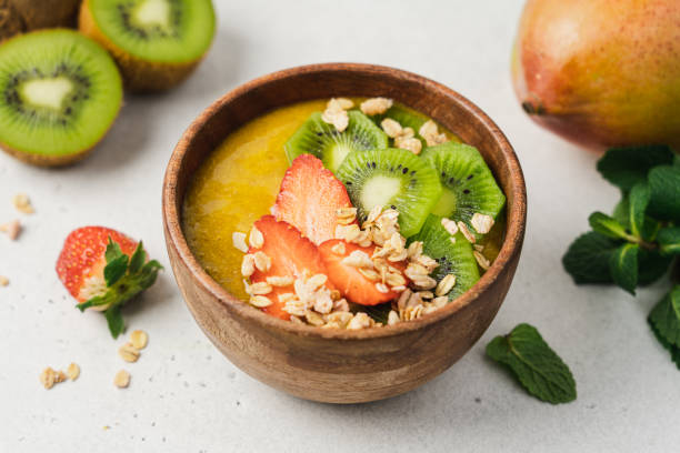 istock Mango smoothie wooden bowl with granola 1367002299