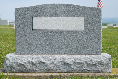 Cemetery headstone close up with no name engraved, new gray granite blank marker in modern contemporary style, ready to add your own text.