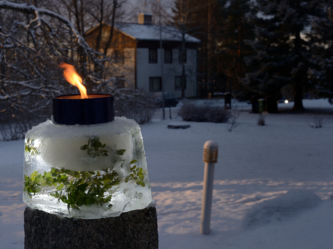 a lit windproof outdoor garden candle in the courtyard on Christmas