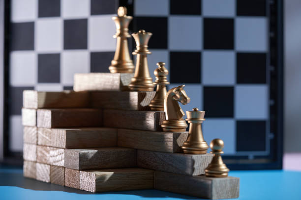 istock chess pieces on the wood stair by ranking 1367004495
