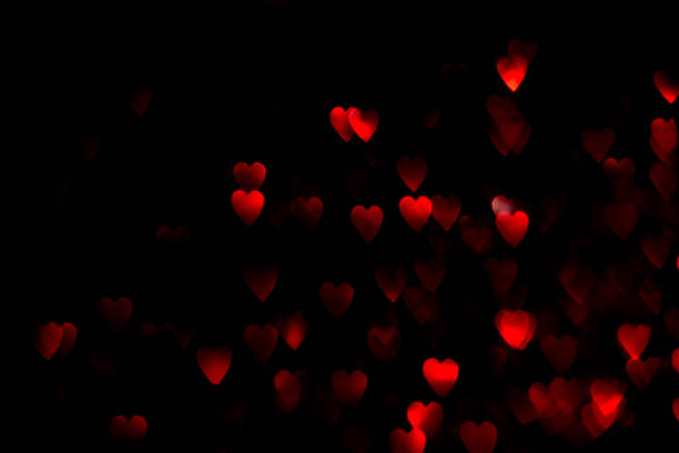 istock Red hearts bokeh lights on black background 1367004636