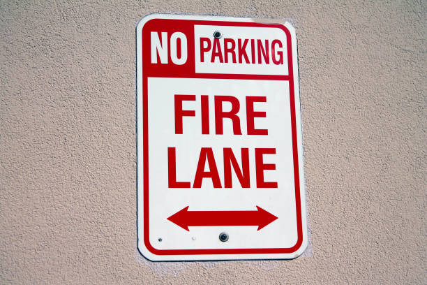 istock No parking, fire lane white and red sign hanged on a concrete wall 1367004848