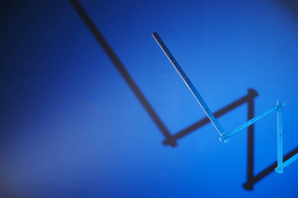 folding ruler with shadow againsat blue background - graph with  growth - folding ruler imagens e fotografias de stock