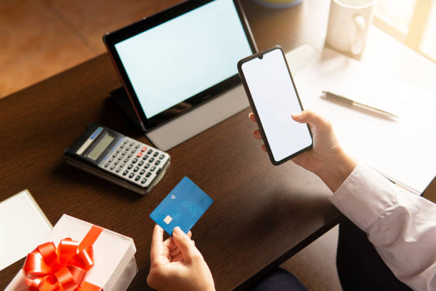 istock Woman using smartphone with credit card, ordering online shopping. Working from home concept 1367005673