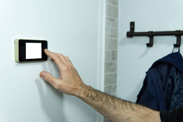 istock Man touching and watching with the digital peep hole, with white background 1367005762