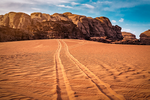 Car tire tracks in red desert. Wadi Rum. Jordan