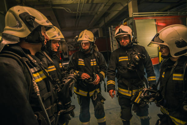 istock Group of firefighters with uniform inside the  fire station preparing for safe rescue 1367007734