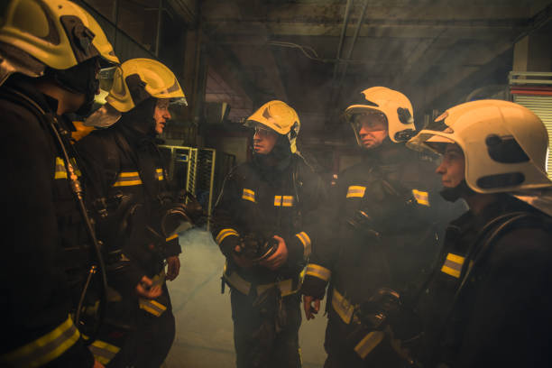 istock Group of firefighters with uniform inside the  fire station preparing for safe rescue 1367007740