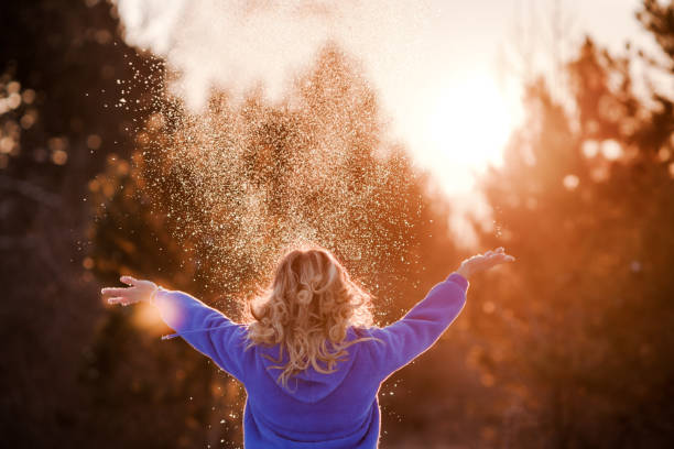 Young woman enjoying winter weather in the snow forest. Cold weather. Winter fashion, holidays, rest, travel concept.