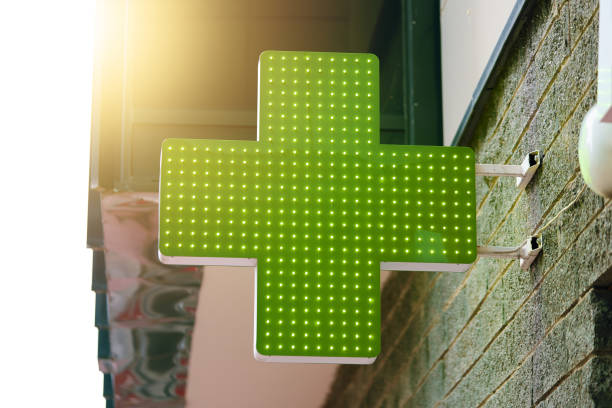 pharmacy green light cross board. - green cross imagens e fotografias de stock