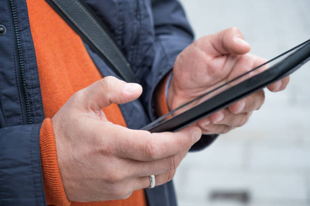 istock Cropped picture of an unrecognizable man using a tablet in the city 1367009063