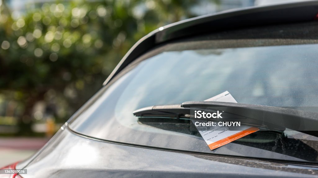 Parking ticket Parking ticket displayed on the windshield of a car. Traffic Stock Photo