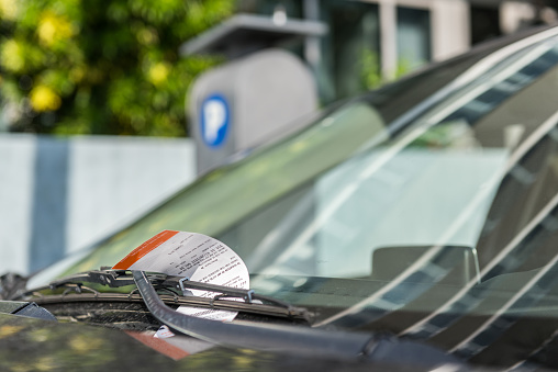 Parking ticket displayed on the windshield of a car.