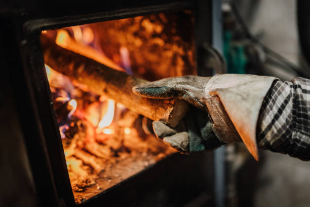 istock Putting a log into a wood burning stove 1367010372
