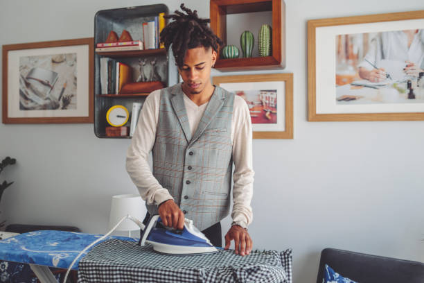 istock Young man ironing his shirt 1367010773